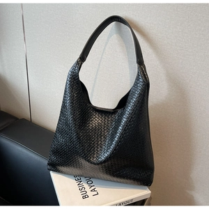 Detail of premium black woven hobo bag showing intricate texture and matte finish