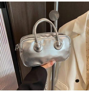 Detail of silver metallic bowling bag featuring dual handles and clearok logo imprint