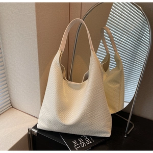Close-up of cream white woven texture on a minimalist hobo tote bag for women