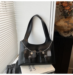 Detail of black PU tote bag with silver charm chain and double front utility pockets