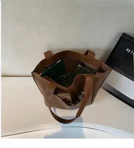Top view of large brown leather tote bag interior showing spacious storage and pockets