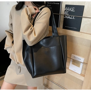 Minimalist black matte leather tote bag with long shoulder strap for daily commuting