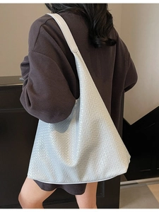 White woven tote bag with large capacity shown in a stylish over the shoulder view