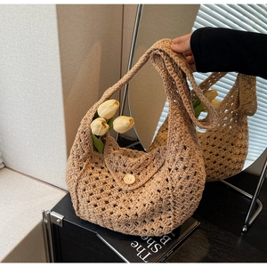Detail of hollow knit texture on a khaki crochet tote bag with round wood button