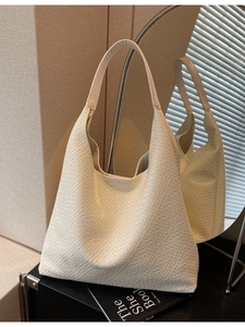 Elegant off-white hobo tote bag with embossed texture and wide shoulder strap