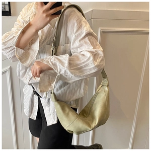 Close-up of light green crescent moon shoulder bag in soft leather with retro silver hardware