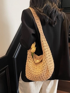 Handmade crochet hobo bag in natural khaki with a wooden button and flower accents