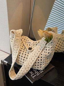 Beige crochet hollow knit shoulder bag with button closure and minimalist hobo style