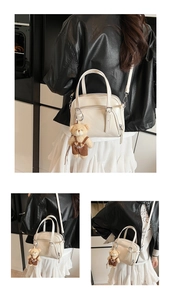 Close-up of white bowling bag with adjustable strap and cute teddy bear charm