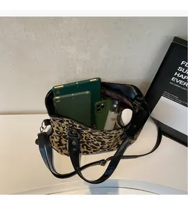 Detailed interior of leopard print tote bag showing spacious storage for daily items