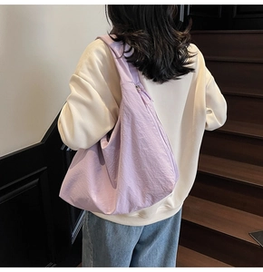 Detail view of large lavender slouchy nylon tote bag with natural wrinkled texture