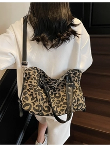Large leopard print tote bag with black leather straps and silver metal hardware