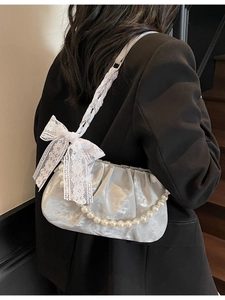 Silver metallic pleated cloud bag with pearl chain and white lace bow detail