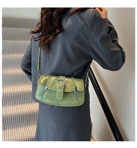 Model wearing a retro matcha green faux leather shoulder bag with silver buckle