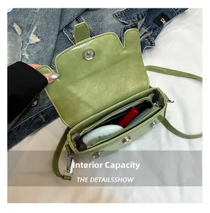 Interior view of grass green faux leather handbag with silver magnetic snap and zipper pocket