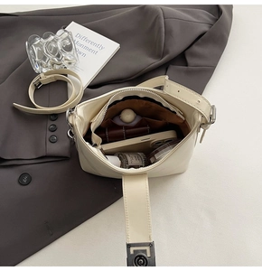Top view of cream white leather bag showing spacious interior with zipper and flap closure