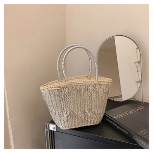 Dettaglio borsa tote in paglia estiva con fili metallici e manico a corda