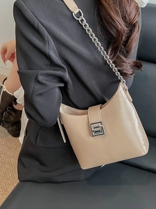 Minimalist beige shoulder bag with silver chain strap and metallic buckle for women