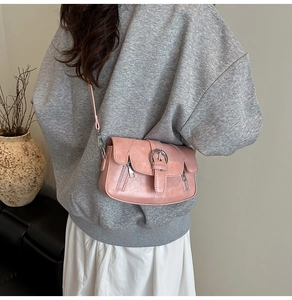 Pink vintage crossbody bag featuring double decorative zippers and metal buckle closure