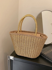 Elegant gold woven tote bag with round handles and beige lining for beach or daily use