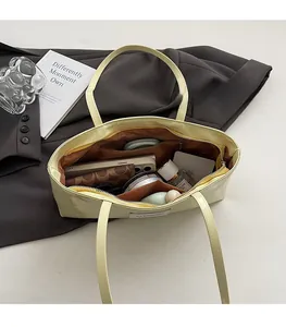 Interior view of the waxed faux leather tote bag showing large capacity and inner pockets
