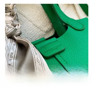 Macro detail of green lychee leather bucket bag with decorative printed silk scarf