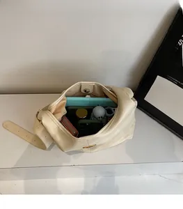 Top-down view of a spacious cream tote bag showing tablet, wallet, and phone inside