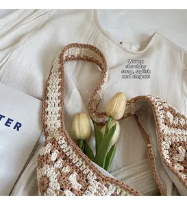 Detailed close-up of handmade crochet bag with brown and white checkered pattern