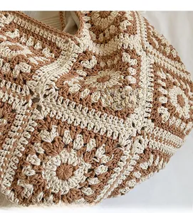 Detailed macro view of bohemian crochet knit bag with beige and brown floral hollow pattern
