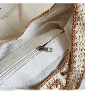 Detailed close-up of woven tote bag with durable brass zipper and cotton lining