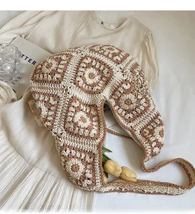 Detail of hand-crocheted geometric knit shoulder bag in beige and brown vintage style