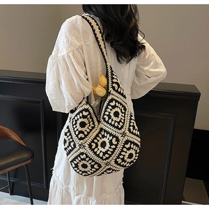 Detail of bohemian crochet shoulder bag with geometric patterns for beach holidays