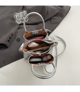 Top view of silver bucket bag showing three compartments and internal storage space