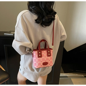 Detail of red bridal handbag with traditional Xi pattern and leather handles