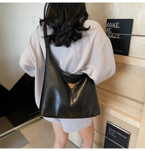 Detailed back view of a black leather crescent hobo bag showing large capacity and grain texture