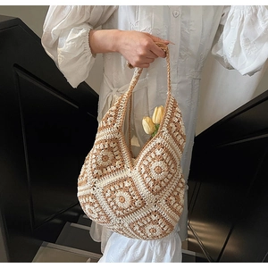 Detail of hand-woven crochet shoulder bag with floral patterns and yellow tulips