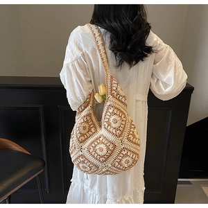 Detailed close-up of a handmade crochet tote bag featuring vintage granny square patterns