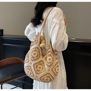 Detail of bohemian crochet hobo bag with floral patchwork patterns for beach vacations