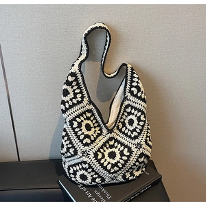 Detail of crochet tote bag with black and white retro granny square floral patterns