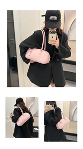 Three-way view of pink baguette underarm bag with litchi grain texture and heart tag