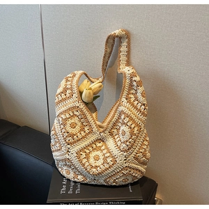 Detail of bohemian crochet knit shoulder bag with ivory and khaki patchwork patterns
