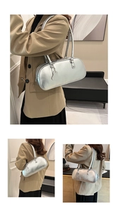 Detail view of silver Boston underarm bag with metallic texture and heart charm