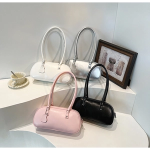 Chic baguette shoulder bags in white, silver, pink, and black displayed on a minimalist stand