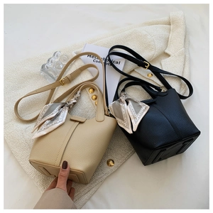 Chic pebble leather bucket bags in beige and black with silk scarf handles and straps