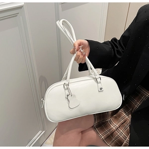 Detailed view of white leather Boston bag with dual handles and adjustable shoulder strap