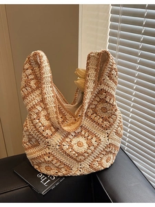 Retro crochet knit tote bag with floral patterns on a dark leather seat background