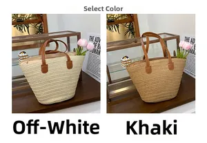 Close-up of cream and khaki woven straw tote bags with brown leather handles