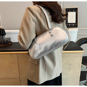 Detail showing the silver metallic wrinkled texture and Y2K style of this shoulder bag