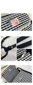 Close-up of contrast plaid canvas bag with lace trim, strawberry charm and magnetic closure
