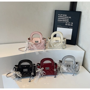 Detailed display of five colorful mini quilted chain bags with pearl bow charms